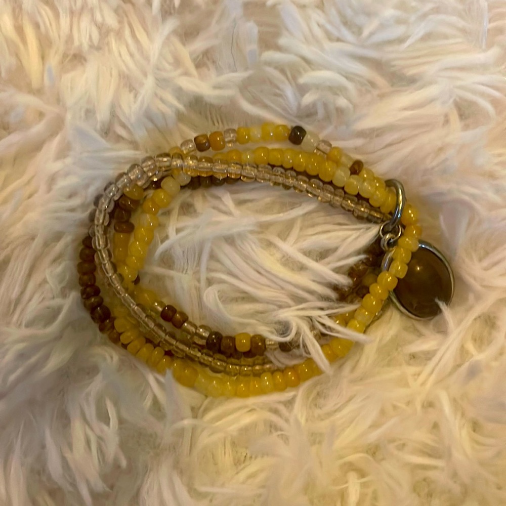 Beige. Brown beaded bracelets with brown stone.  3 bracelets total.